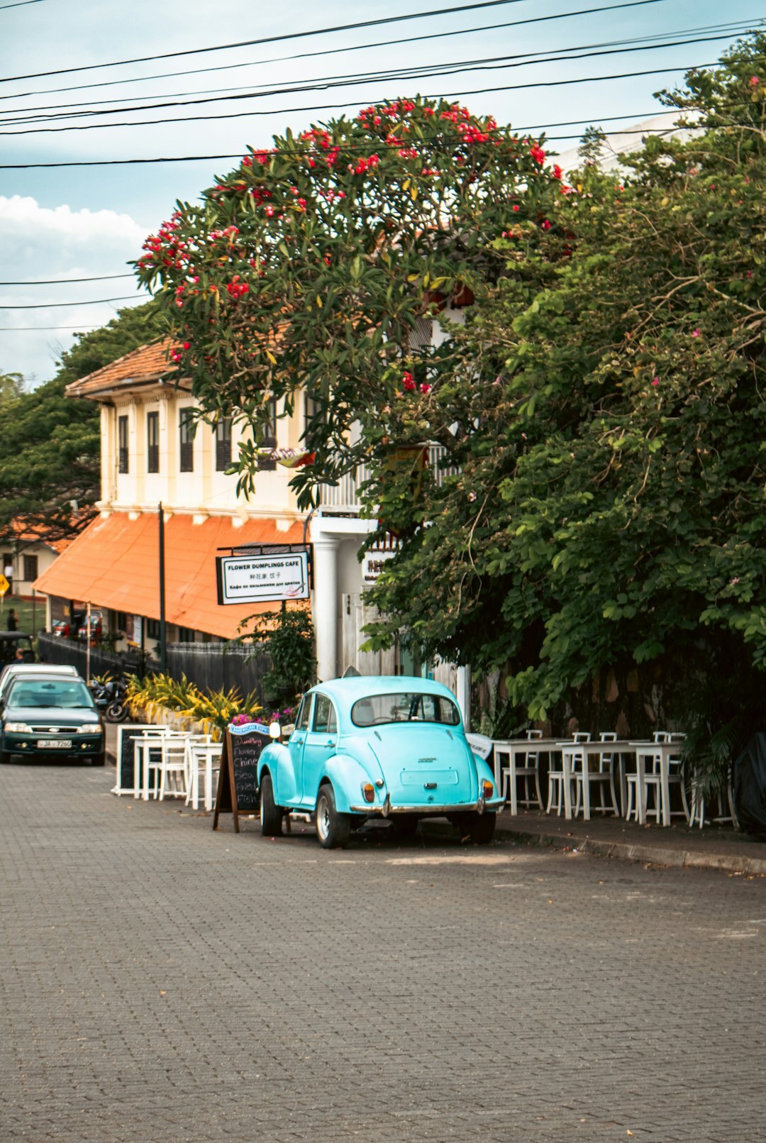 Classic vintage automobile parked on a cobblestone colonial street