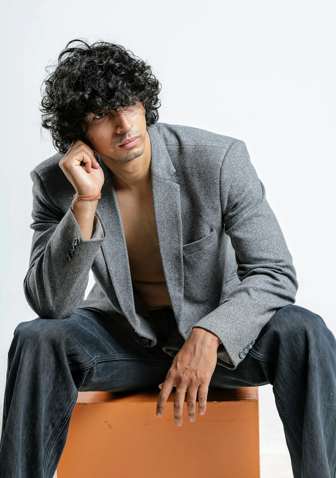 Studio portrait of a confident Hispanic man in a tailored blazer