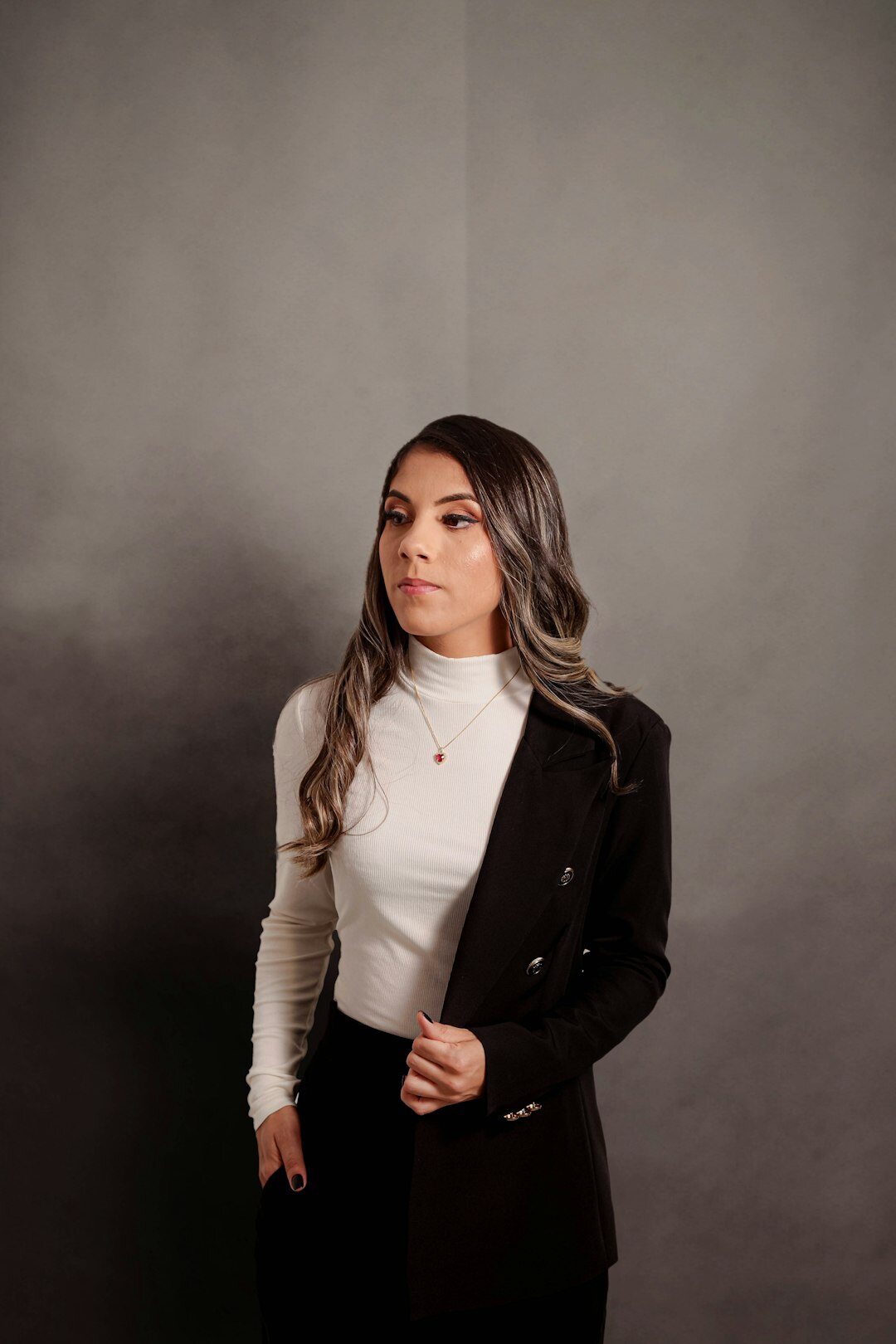 Studio portrait of a professional Hispanic woman with an elegant blazer