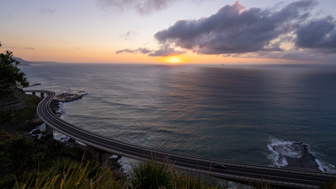 Scenic coastal bridge road with ocean view at golden hour